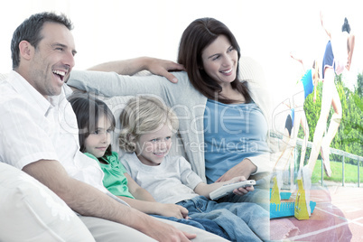 Composite image of happy family watching television together