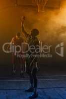 Victorious basketball player raising his arms up