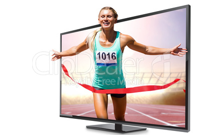 Composite image of sportswoman finishing her run