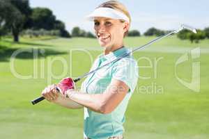 Composite image of woman golf player looking the camera