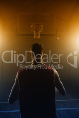 Portrait of basketball player front the back in front of a baske