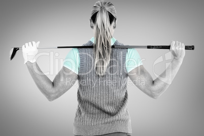 Composite image of pretty blonde playing golf