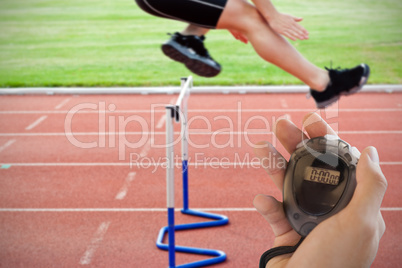 Composite image of coach is holding a stopwatch