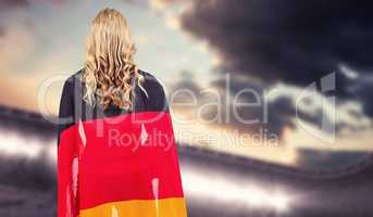 Composite image of athlete with german flag wrapped around her b