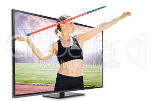 Composite image of front view of sportswoman practising javelin