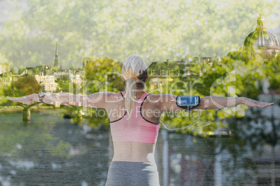 Composite image of a beautiful athlete stretching her arms