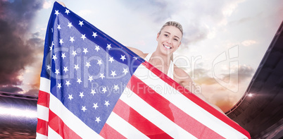 Composite image of female athlete holding american flag