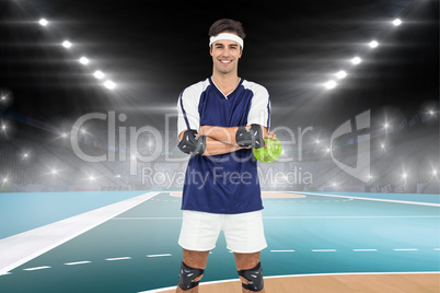 Composite image of sportsman standing with ball on white backgro