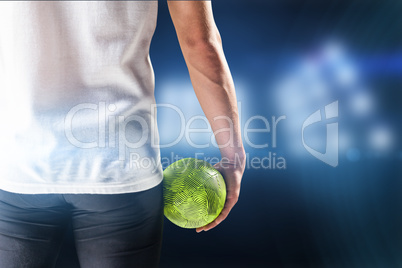 Composite image of mid section of athlete man holding ball