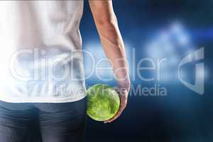 Composite image of mid section of athlete man holding ball