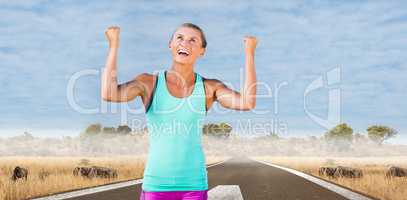 Composite image of athletic woman with arms up