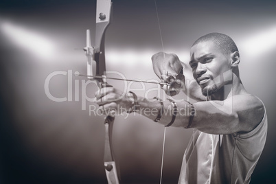 Composite image of close up view of man practicing archery