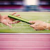 Man passing the baton to partner on track