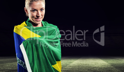 Athlete with brazilian flag wrapped around her body