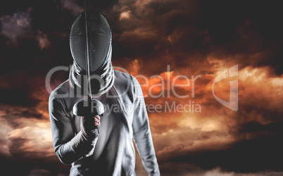 Composite image of man wearing fencing suit practicing with swor