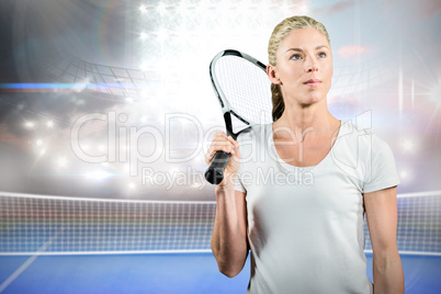 Sportswoman holding a tennis racket and looking away