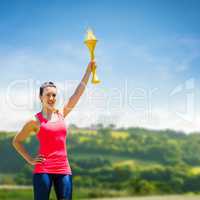 Composite image of sporty woman posing and smiling with olympic