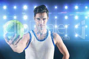 Composite image of portrait of happy male athlete holding a ball