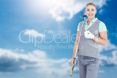 Pretty blonde posing with golf equipment