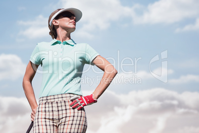 Focused woman playing golf