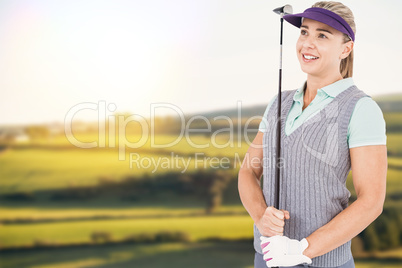 Composite image of pretty blonde playing golf