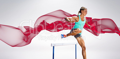 Composite image of sportswoman practising the hurdles