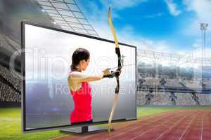 Composite image of side view of woman practicing archery