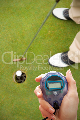 Close up of woman is holding a stopwatch