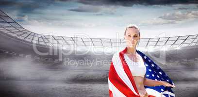 Portrait of sporty woman holding American flag