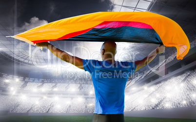 Composite image of sporty man holding a german flag