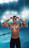 Composite image of swimmer holding goggles