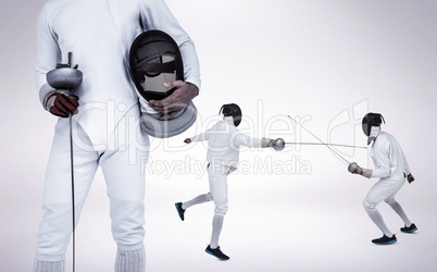 Composite image of swordsman holding fencing mask and sword