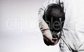 Composite image of mid-section of man standing with fencing mask