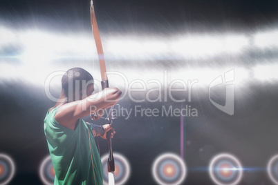 Composite image of rear view of sportsman doing archery