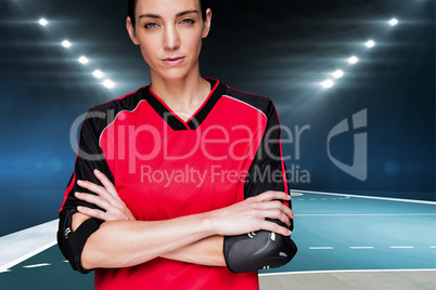Composite image of female athlete posing with elbow pad and cros