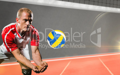 Composite image of sportsman diving while playing volleyball