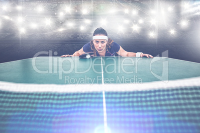 Composite image of confident female athlete leaning on hard tabl