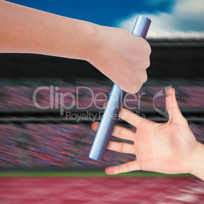 Composite image of close up of sportsman is holding a baton for