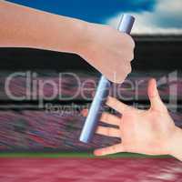 Composite image of close up of sportsman is holding a baton for