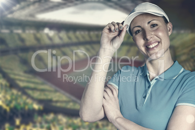 Sportswoman posing with touching cap