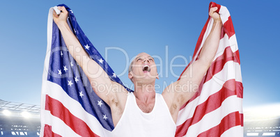 Composite image of athlete posing with american flag after victo