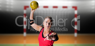 Composite image of female athlete with elbow pad throwing handba