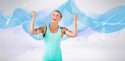 Composite image of athletic woman with arms up