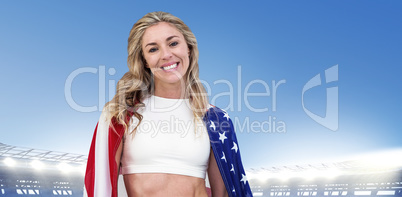 Composite image of athlete with american flag wrapped around his