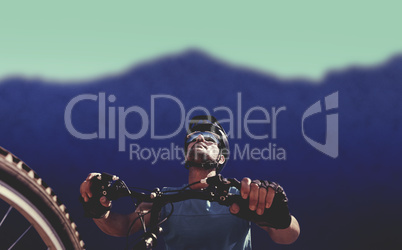 Composite image of man cycling with mountain bike