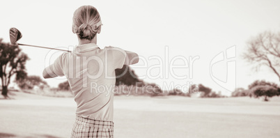 Composite image of woman playing golf