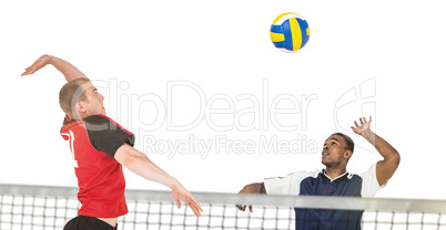 Composite image of sportsman hitting volleyball