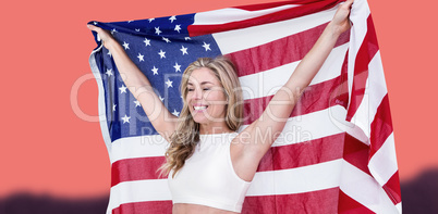 Composite image of athlete posing with american flag after victo