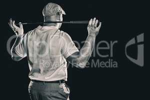 Composite image of rear view of golf player holding a golf club