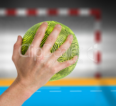 Composite image of sportswoman holding a ball